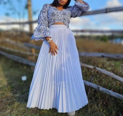 Pleated white maxi skirt with elastic waist and patterned off-shoulder top