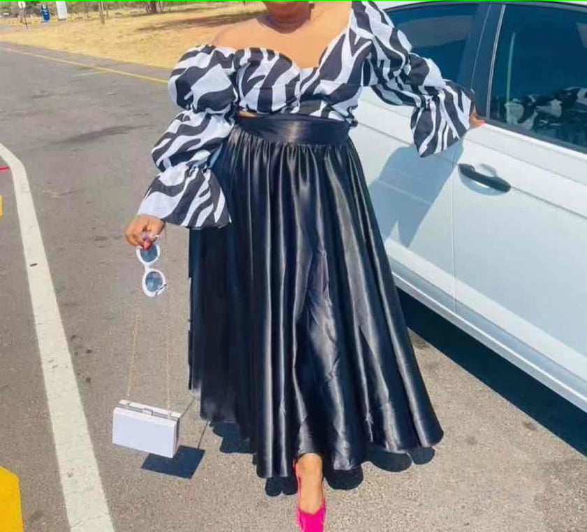 Off-shoulder striped blouse with black maxi skirt