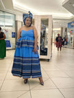 Strapless tiered maxi dress and blue knotted headwrap, blue bodice with striped tiers