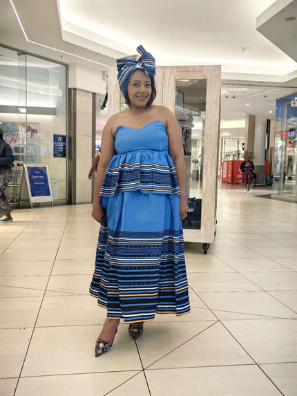 Strapless tiered dress with blue headwrap, blue bodice and striped skirt