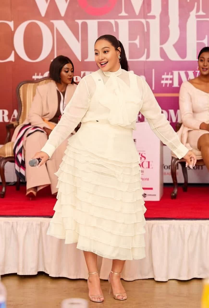 Women's cream sheer tiered midi set with ruffled skirt and long-sleeve top.