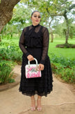 Women's black sheer tiered midi set with ruffled skirt and long-sleeve top.