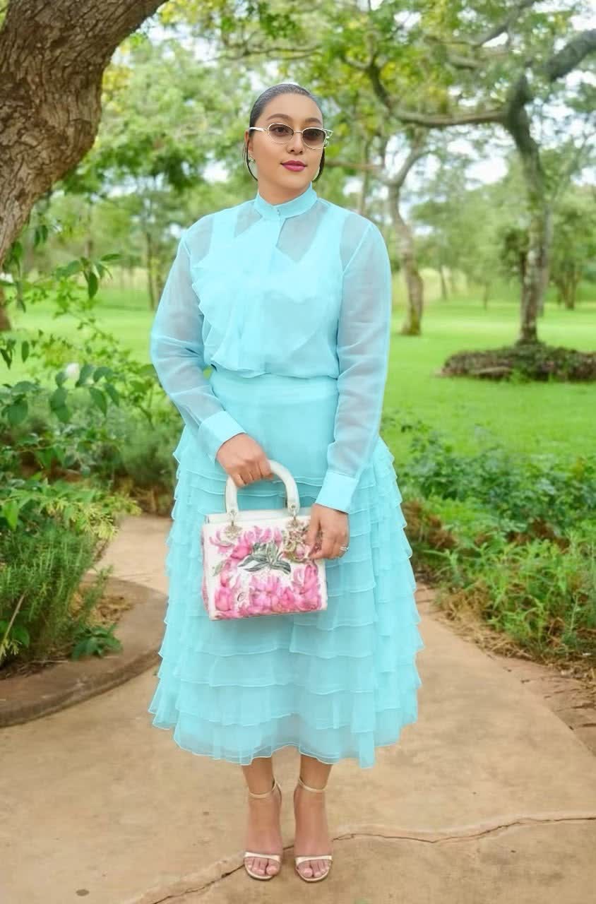 Women's sky blue sheer tiered midi set with ruffled skirt and long-sleeve top.