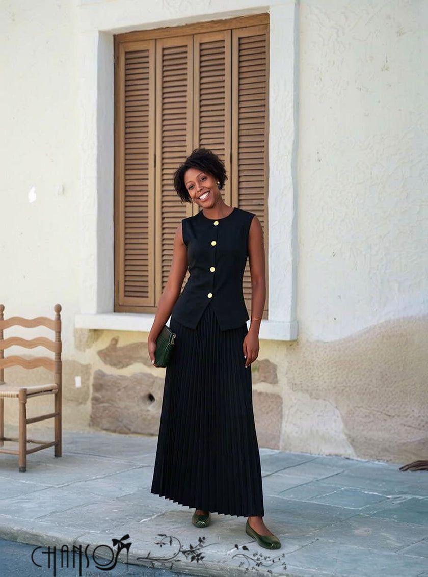 Black two piece set with sleeveless gold button top and pleated maxi skirt