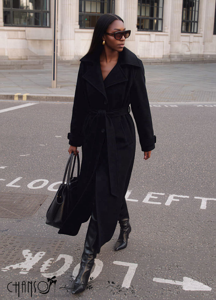 Black belted maxi coat with lapel collar, long sleeves and button front