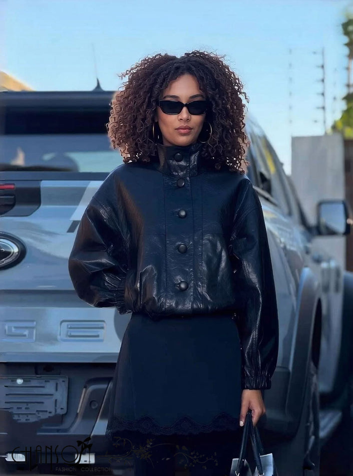 Black leather stand-collar jacket with snap buttons and long sleeves