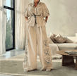 Cream puff-sleeve top and wide-leg pants with floral embroidery on the legs