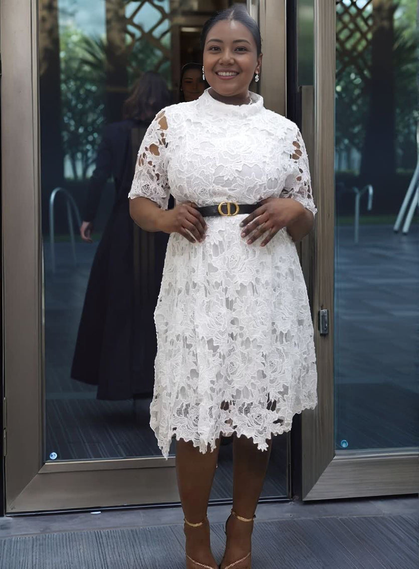 White lace evening dress with puff sleeves and belted waist, scalloped knee-length hem