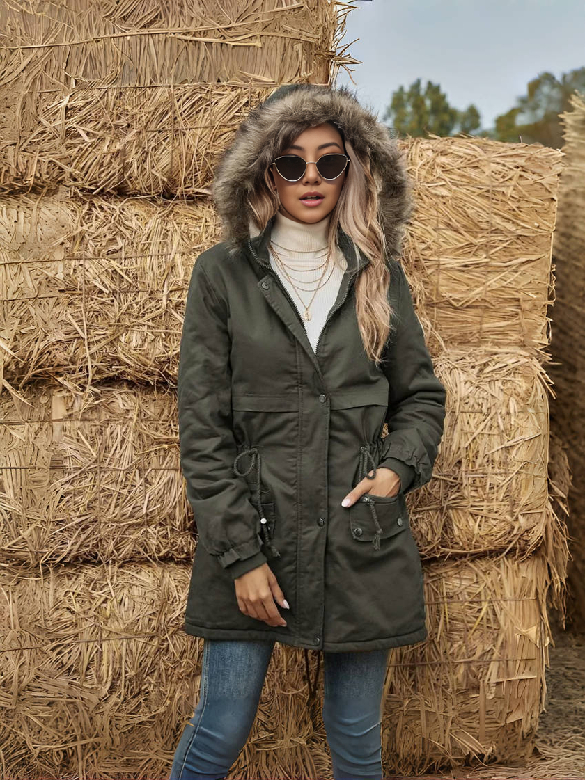 Dark green winter parka with faux fur hood trim and adjustable waist tie