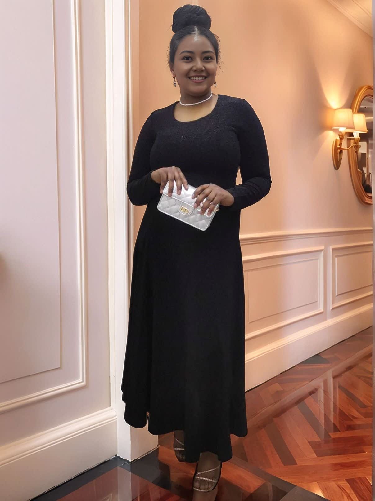 Black long-sleeve maxi dress with stretch waist and fitted bodice, cuffed sleeves