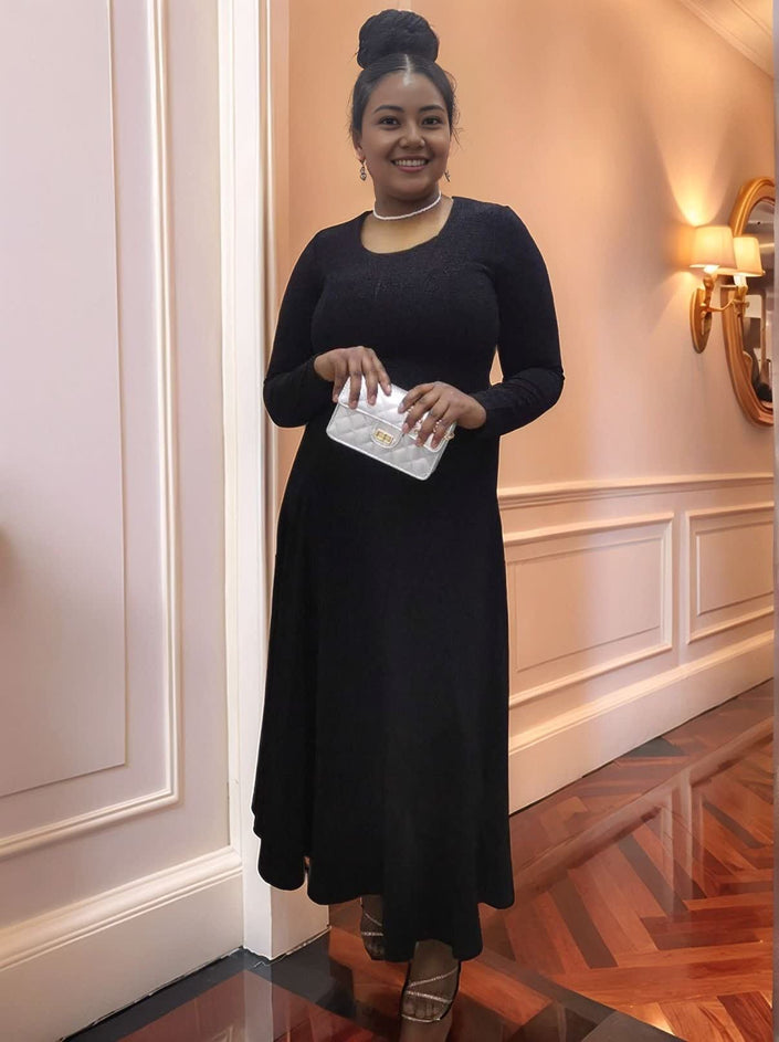Black long-sleeve maxi dress with stretch waist and fitted bodice, cuffed sleeves