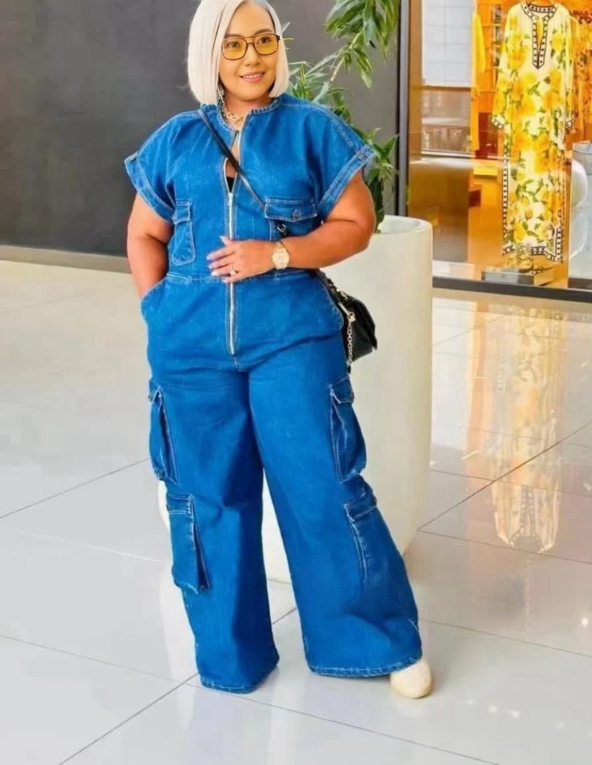 Blue denim utility jumpsuit with short sleeves, front zipper, and cargo pockets