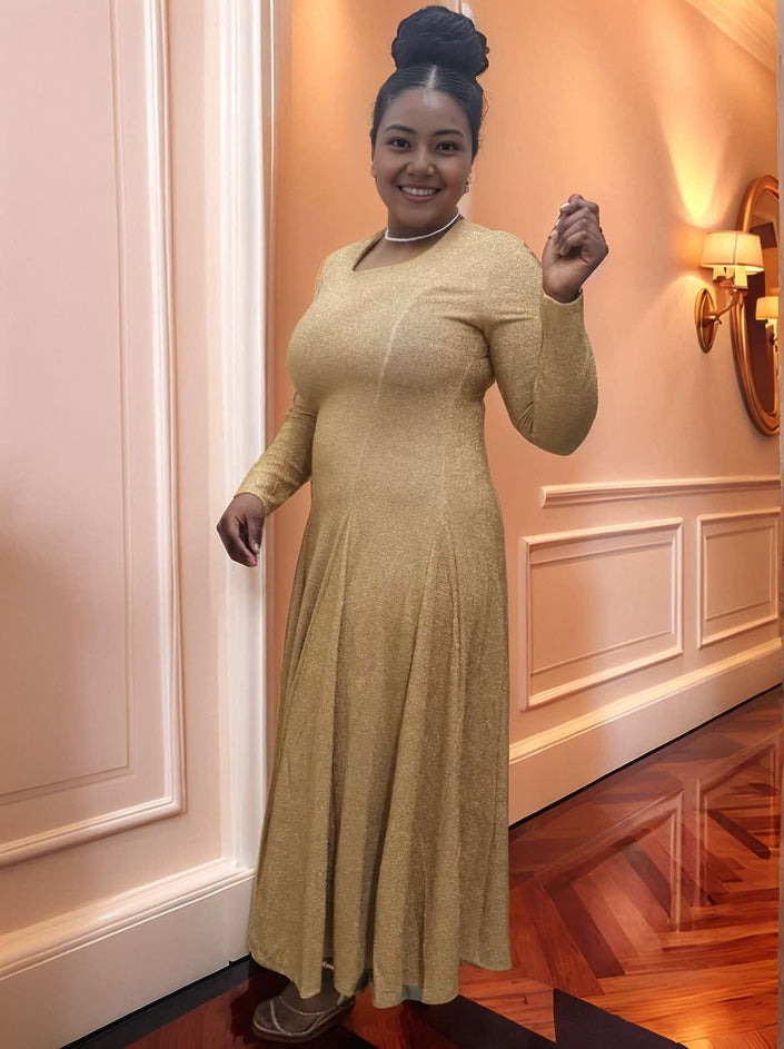 Gold long-sleeve maxi dress with stretch waist and gathered skirt, close front view