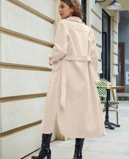 Knee-length belted trench coat in beige, buttoned front with flap pockets