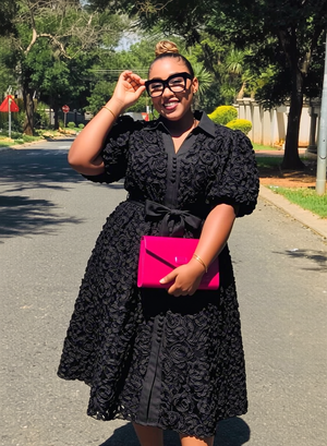 Black women’s midi shirt dress with puff sleeves, 3D floral pattern, and belt