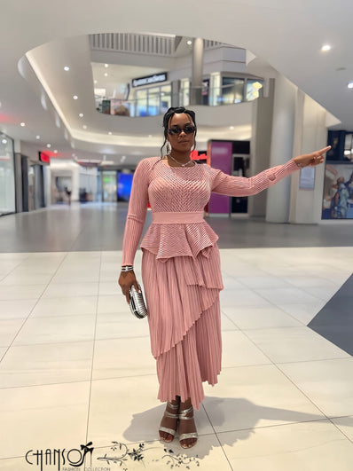 Light mauve long-sleeve peplum top with layered ruffles and pleated asymmetric maxi skirt