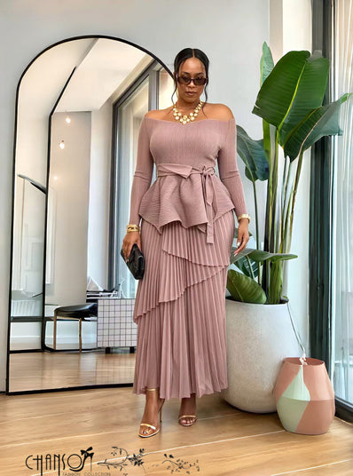 Blush pink long-sleeve peplum top with ruffled tiers and matching pleated maxi skirt set