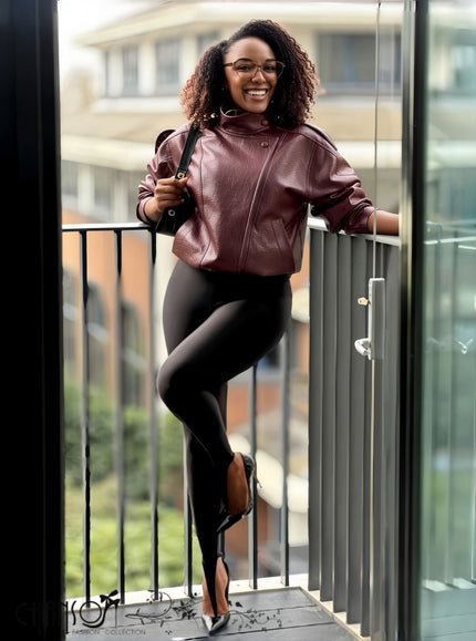 Cropped maroon leather jacket with stand collar and front zipper, relaxed oversized fit