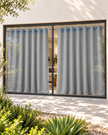 Denim blue textured eyelet curtains with pale floral motifs and grommet top