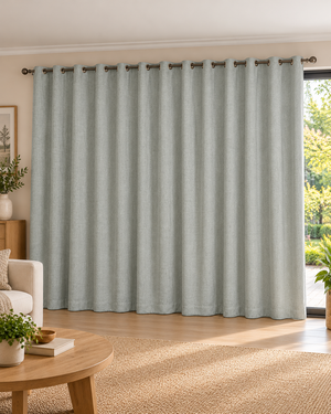 Grey textured eyelet curtain panel with ring grommets along the top edge