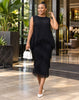 Black pleated two-piece set with a sleeveless fringed top and midi skirt