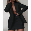 Black blazer dress set with notched lapels and matching mini skirt, buttoned front.