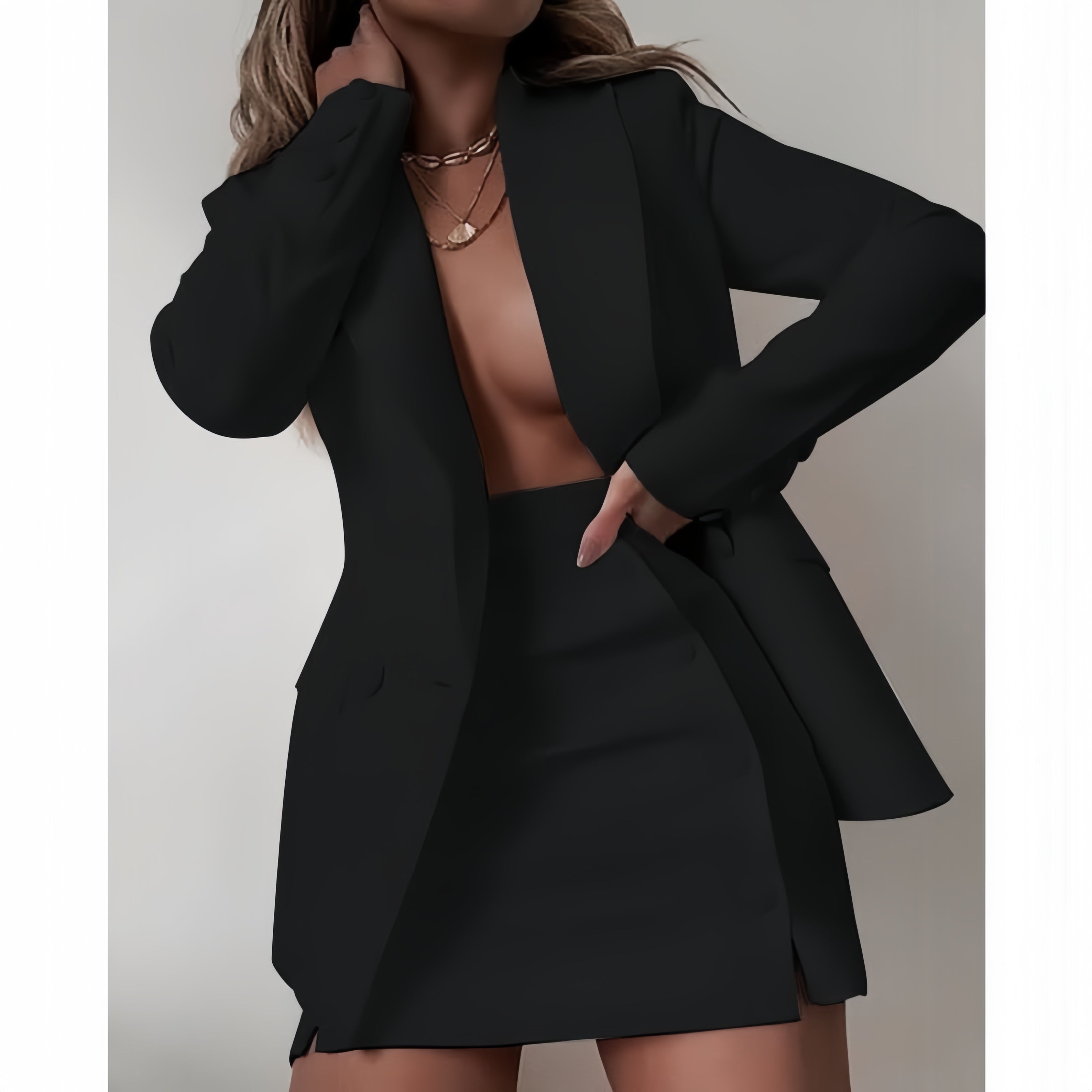 Black blazer dress set with notched lapels and matching mini skirt, buttoned front.
