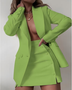 Green blazer dress set with notched lapels and matching mini skirt, buttoned front.