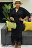 Black twin set: pinstripe kimono-style top with fringe, pleated skirt
