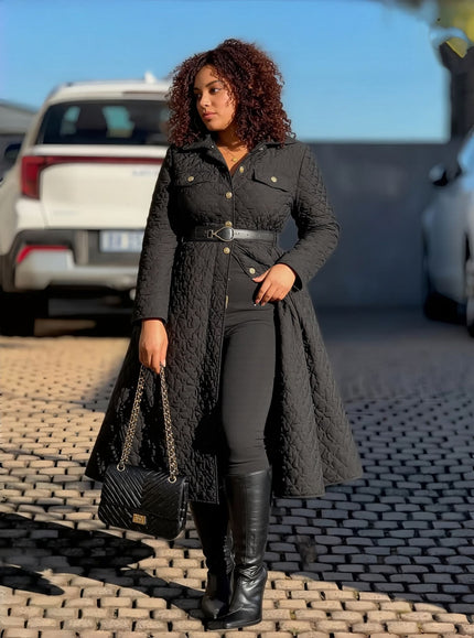 Quilted black A-line coat with collar and belt, long sleeves.