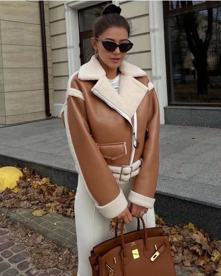 Brown shearling biker jacket with zip front, white shearling trim at collar and cuffs