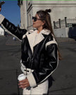 Black shearling biker jacket with zip front, shearling collar and cuffs, belt loops