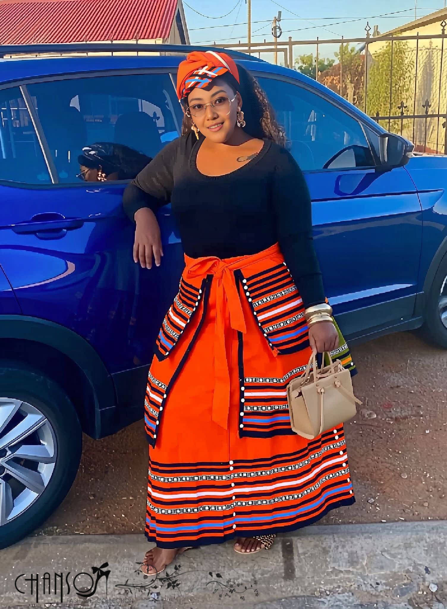 African maxi skirt set: black top with orange striped maxi skirt and tied waist sash