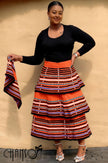 African maxi skirt set: black long-sleeve top with orange striped tiered maxi skirt