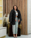 Black plush fur coat with long sleeves and open front