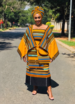 Geometric midi skirt with yellow-and-blue striped yoke and black pleated skirt