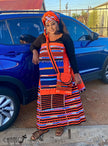 Geometric print maxi skirt set with orange headwrap, black top, long striped skirt