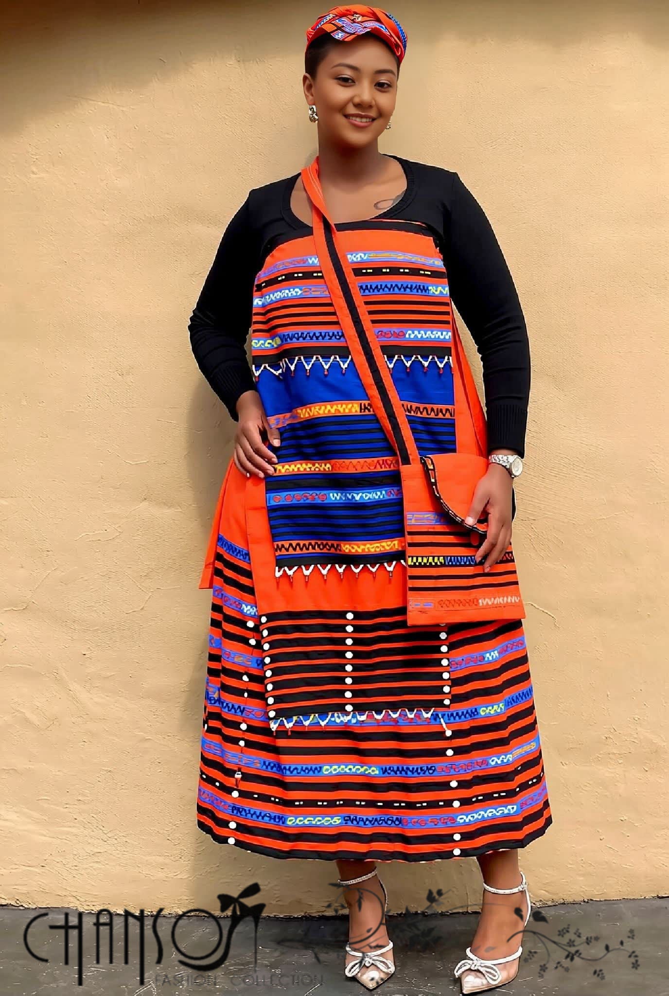 Geometric print maxi skirt set, orange headwrap and black cardigan sleeves