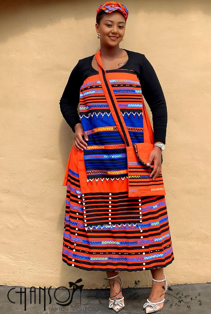 Geometric print maxi skirt set, orange headwrap and black cardigan sleeves