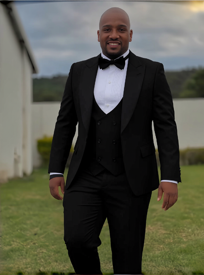 Men's black three-piece tuxedo suit with shawl lapel jacket, bow tie, and waistcoat