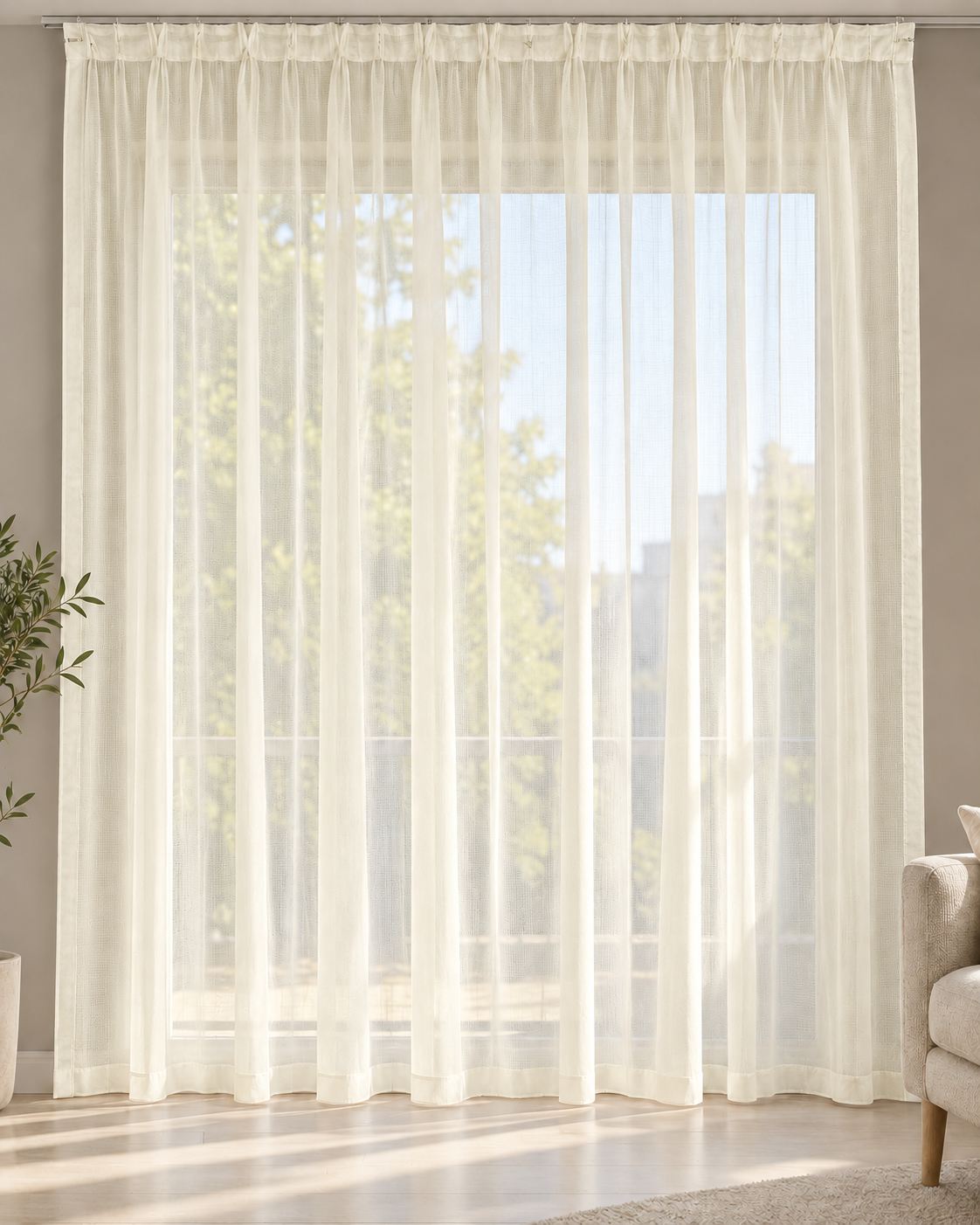 Cream sheer curtain with pencil pleats and a lightweight open weave