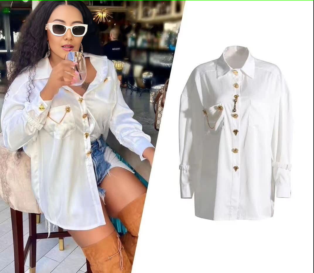 White long-sleeve blouse with ruffle front, gold button placket and pintuck detail