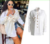 White long-sleeve blouse with ruffle front, gold button placket and pintuck detail