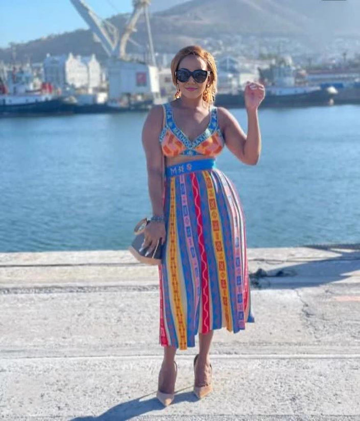 Colorful geometric knit midi set: sleeveless crop top and pleated skirt with striped pattern