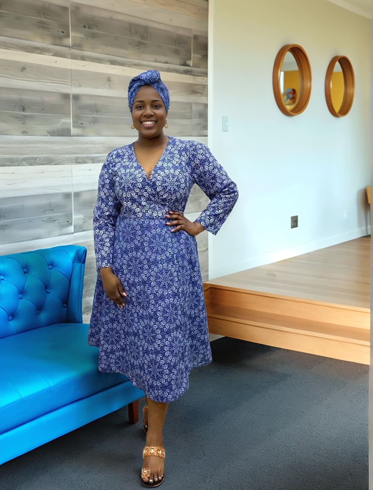 Blue floral wrap dress with V-neck, long sleeves, midi length.