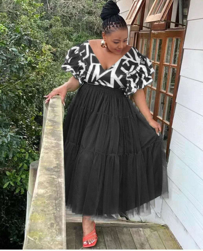 Black tiered tulle maxi dress with ruffled puff sleeves and white graphic bodice