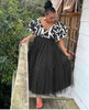 Black tiered tulle maxi dress with puff sleeves and patterned V-neck bodice