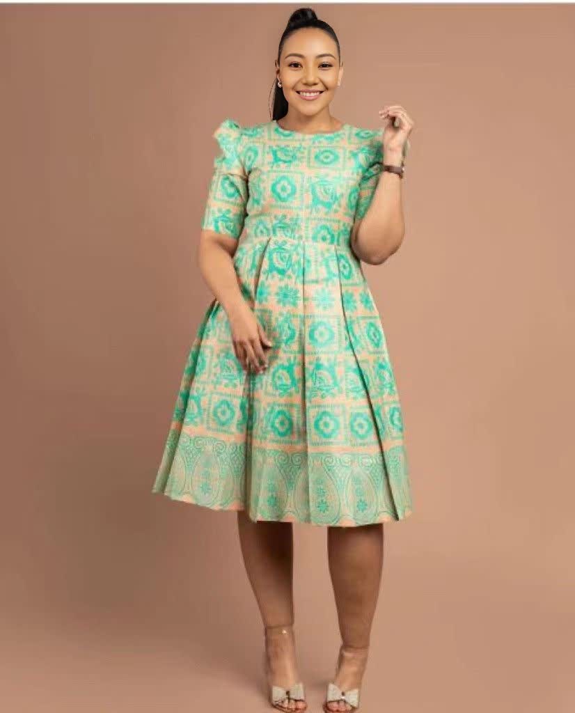 Printed puff-sleeve midi dress with teal and white geometric pattern, round neckline