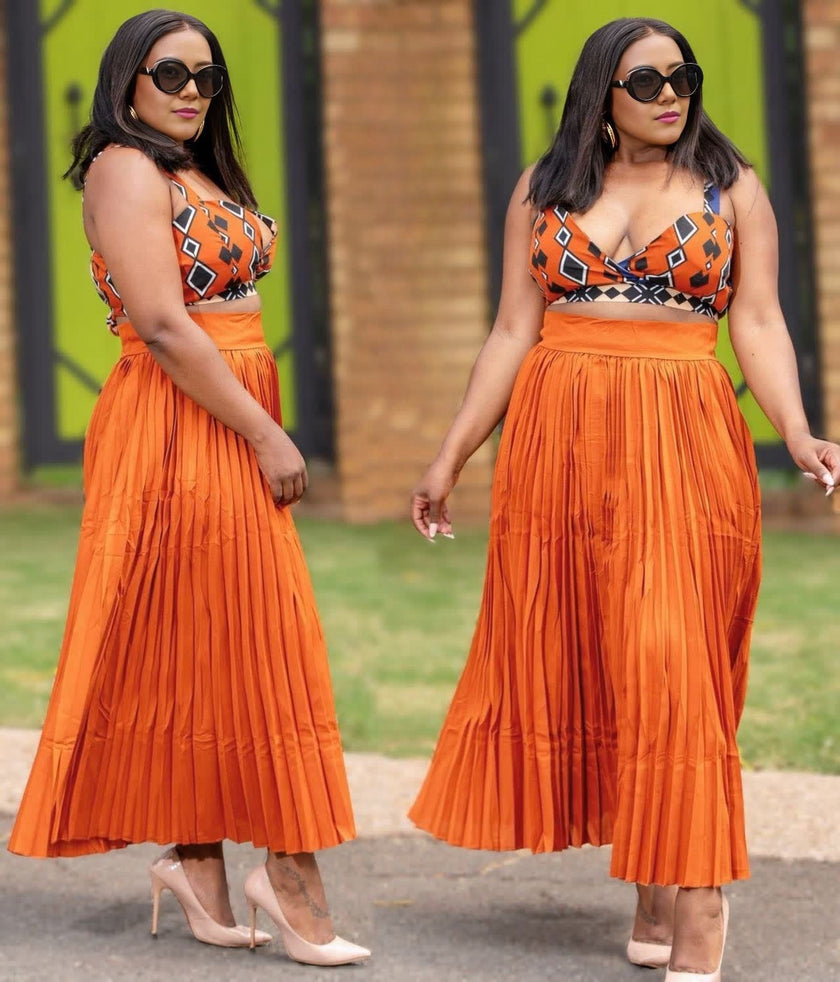 Orange pleated midi skirt with geometric printed wrap-style top, twin set