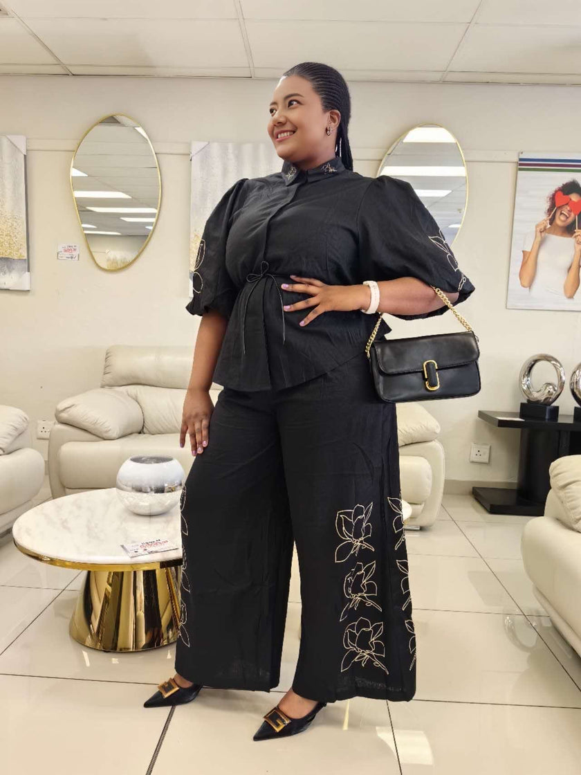 Black puff-sleeve floral twin set with wide-leg pants, embroidered detail